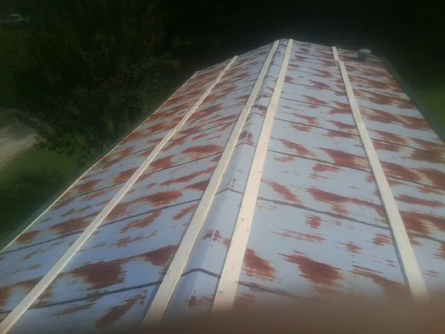 Rusted metal roof panels with new wood purlins before replacement — Storm Damage Roof Repair in Leechburg by Roofing Brothers