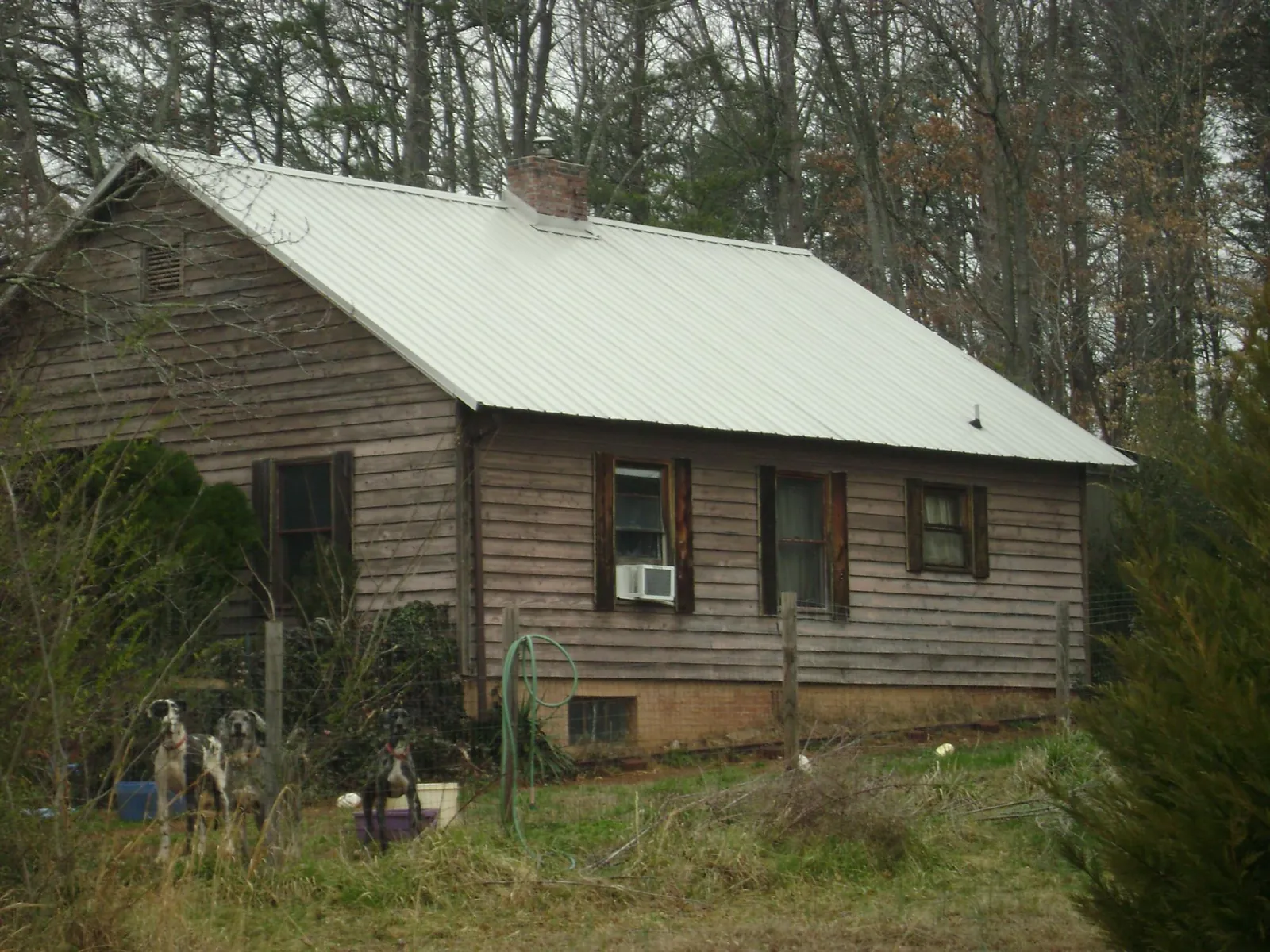 White metal roof on an old wood sided farmhouse, from a Metal Roof Installation job in Leechburg